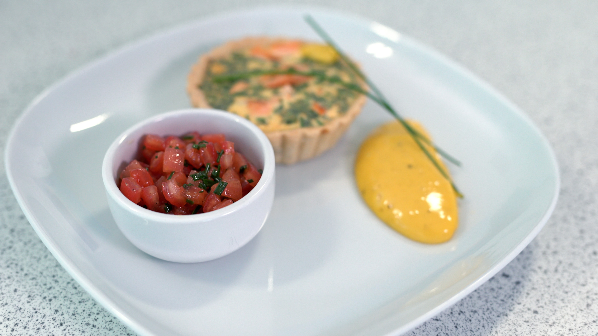 Wild Alaska pink salmon and tarragon tart, tomato concasse and chive salad, served with rapeseed oil